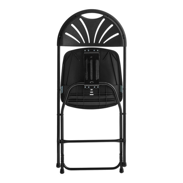 A black folding chair with a fan-shaped cutout design on the backrest, shown in a folded position.