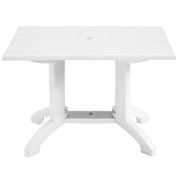 A Grosfillex white rectangular table with pedestal legs.