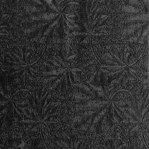 A black laminated corrugated cake circle with a pattern.