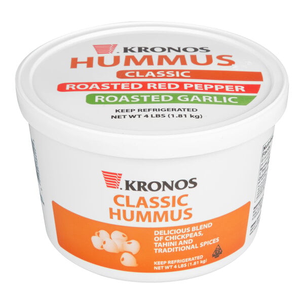 A white plastic tub labeled 'Kronos Classic Hummus' with orange and white graphics and text, featuring images of chickpeas and product information.