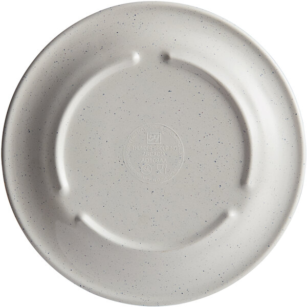 A beige plate with a speckled surface.