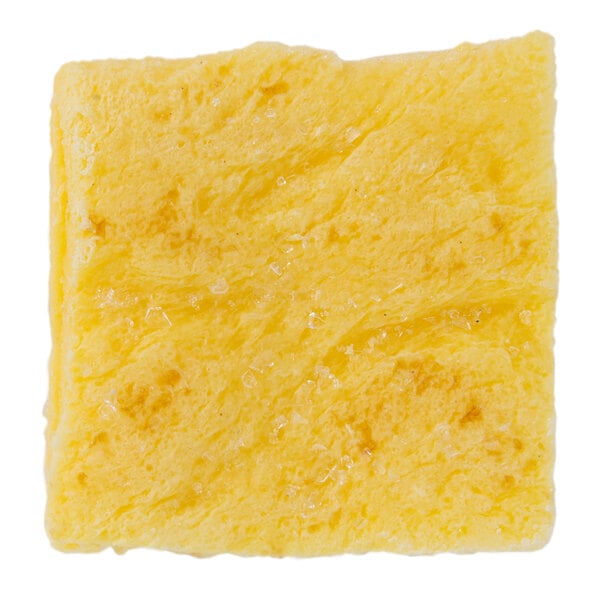 A yellow square scrambled egg patty with white specks.