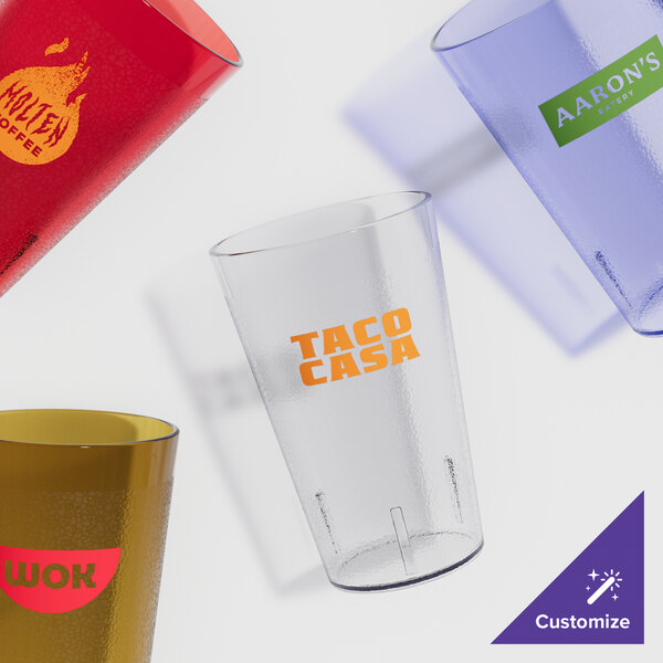 A group of Cambro amber plastic tumblers with a logo on one.