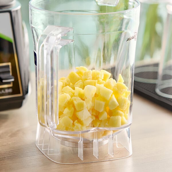A blender with diced pineapple chunks in it.