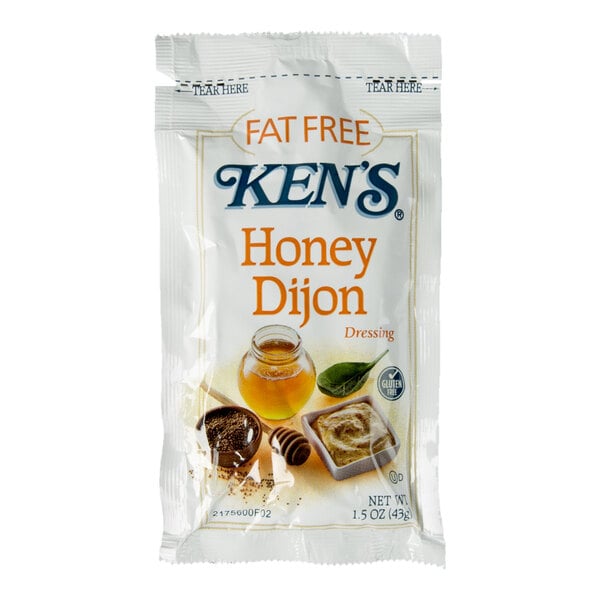 A single-serve packet of Ken's Fat Free Honey Dijon Dressing with images of honey, mustard, and a leaf on the front.
