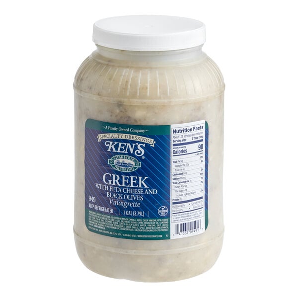 A 1-gallon container of Ken's Greek vinaigrette with feta cheese and black olives dressing.
