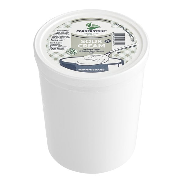 A white Friendship Dairies sour cream tub with a lid and label.