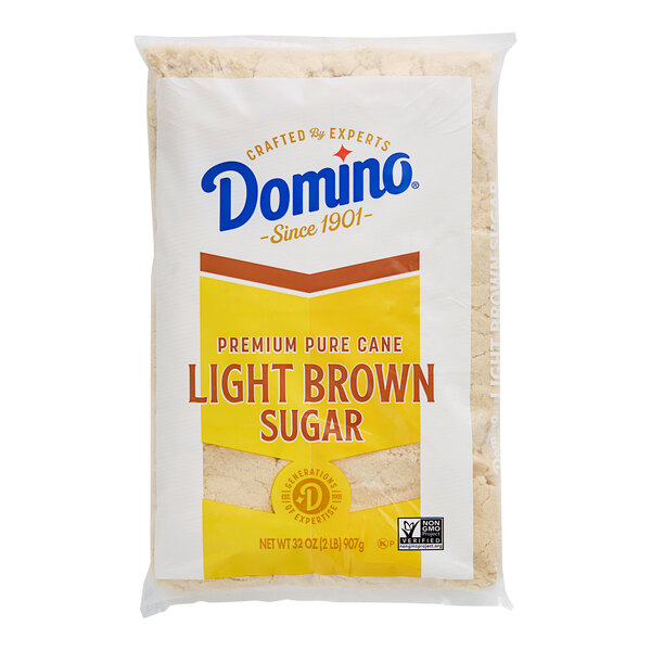 A yellow and white bag of Domino Light Brown Sugar.