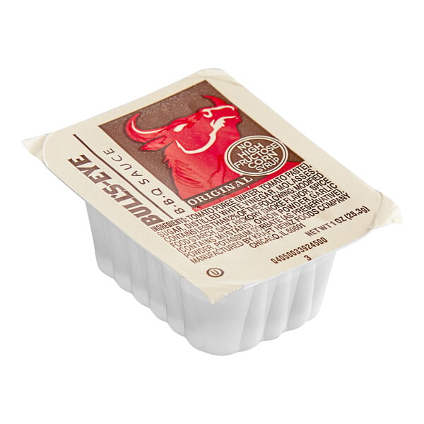 A single-serve plastic dipping cup with a sealed lid labeled 'Bull's-Eye BBQ Sauce' featuring a red bull graphic.