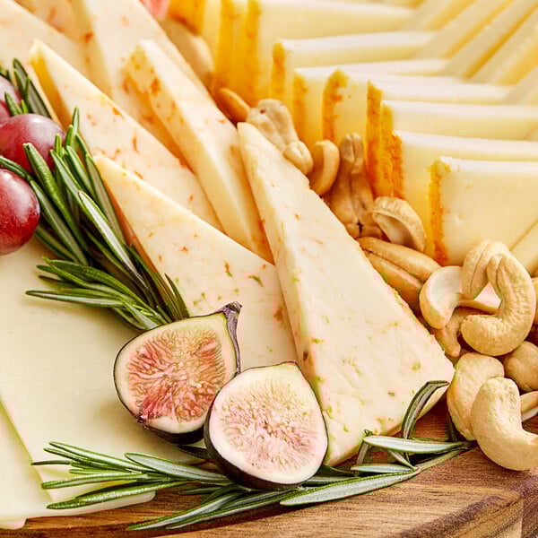 A platter of Ellsworth Cooperative Creamery Ghost Pepper Monterey Jack cheese with grapes and nuts.