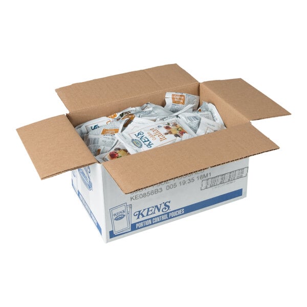 An open cardboard box filled with individually packaged condiment pouches.