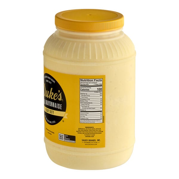 A white plastic container of Duke's Heavy Duty Mayonnaise with a yellow label and lid.