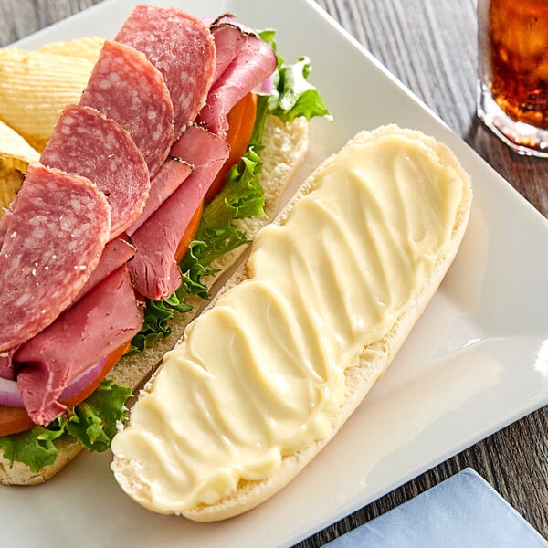 A sandwich on a plate with Duke's Heavy Duty Mayonnaise on it.