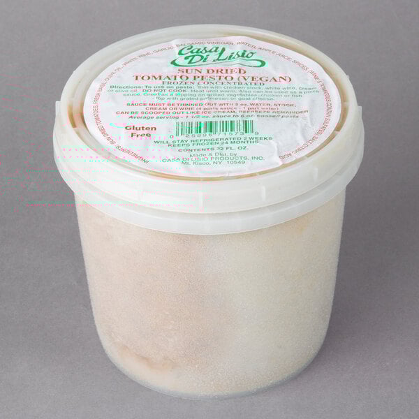 A white container of Casa Di Lisio Sundried Tomato Pesto Concentrate with a label.