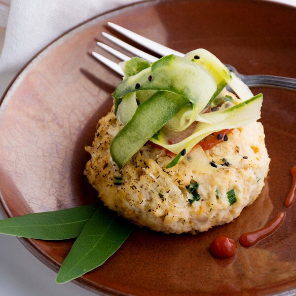 A plate with a Handy Ultimate Crab Cake and vegetables on it.