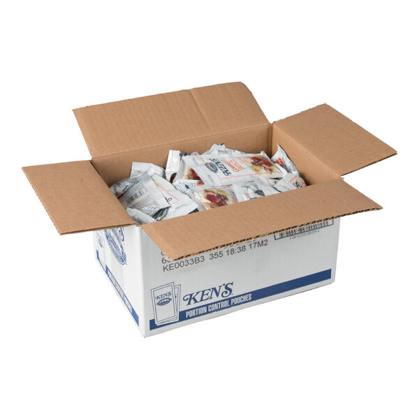 An open cardboard box filled with individual condiment packets.