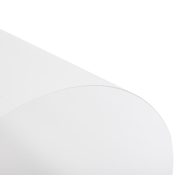 A close-up of a white translucent paper on a white surface.