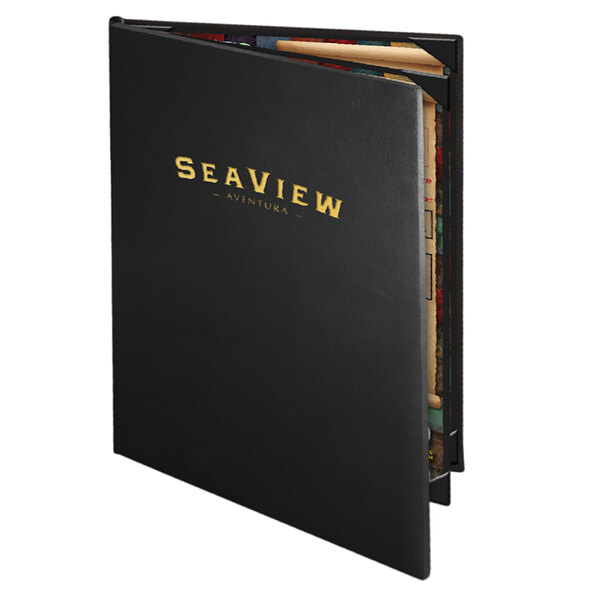 A black leather-like Menu Solutions Chadwick menu cover with gold text on a table.