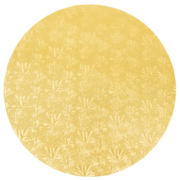 An Enjay gold round cake drum with a floral pattern on the edge.