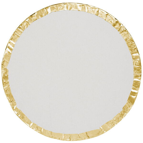 A round white plate with gold foil around it.