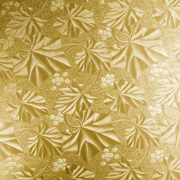A white surface with a gold leaf pattern.