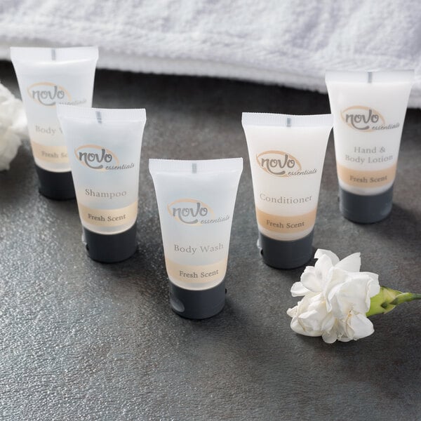 A clear plastic bottle with white label reading "Novo Essentials Hotel and Motel Body Wash"