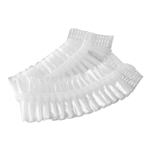 A set of clear disposable shower caps with elastic bands.
