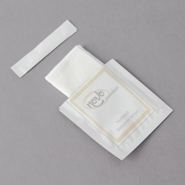 A white package of Novo Essentials Hotel and Motel Makeup Remover Wipes with a white paper strip.