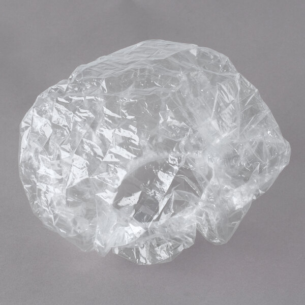 A clear plastic bag with a white background containing Noble Eco Novo Natura shower caps.