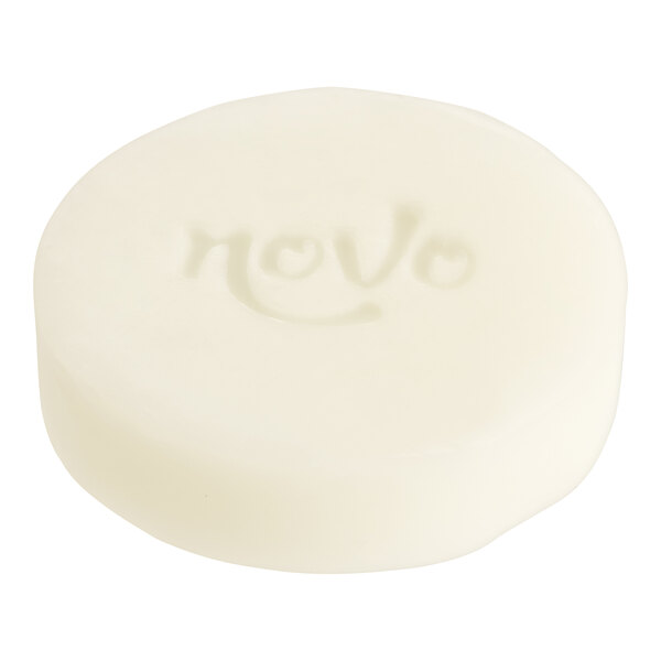 A white round Noble Eco Novo Terra soap bar with text on it.