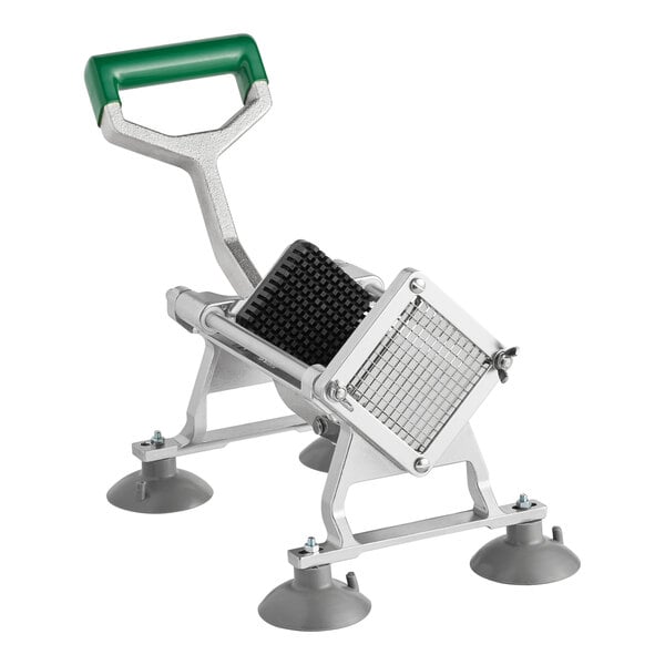A heavy-duty French fry cutter with a green handle and suction cup feet.