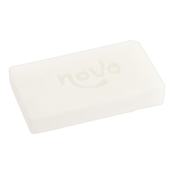 A white rectangular wrapped soap bar with black and white text.