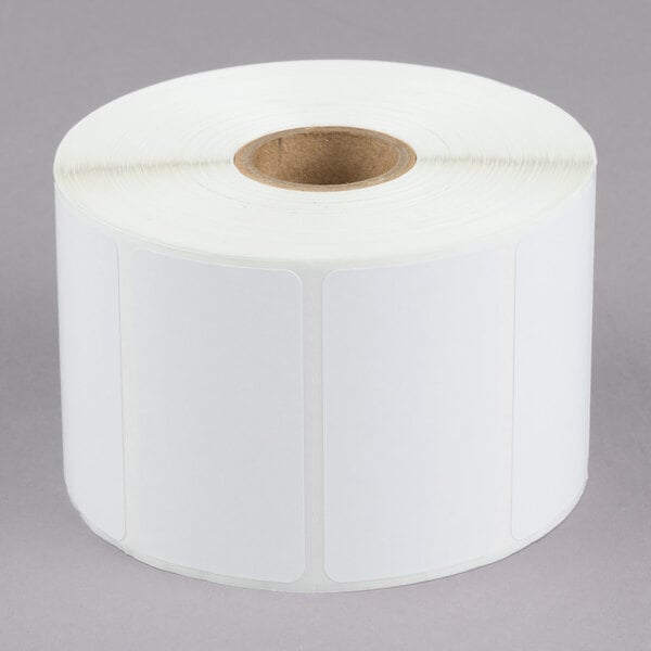 A white roll of paper with a roll of white labels.