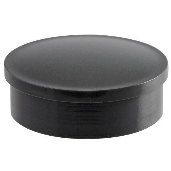 A black round screw cover with a knob.