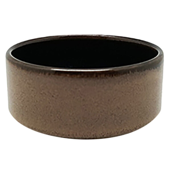 A brown porcelain ramekin with a black rim.