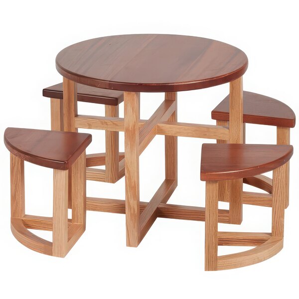 A round wooden table set on a wood countertop riser with stools.