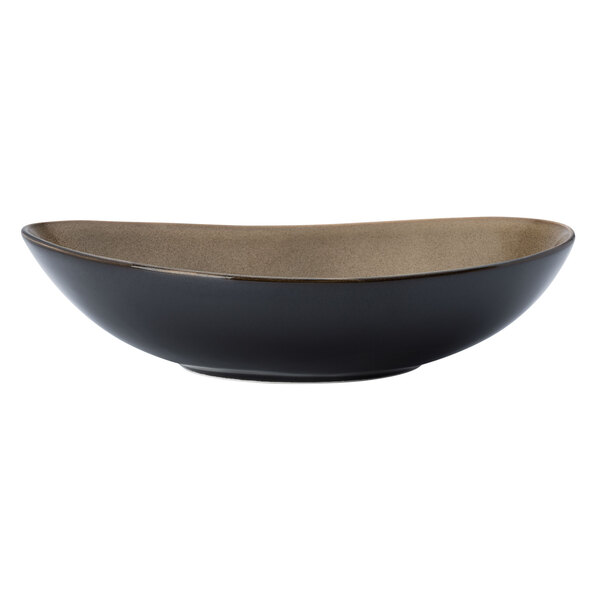 A white porcelain soup bowl with a black bowl and brown rim.