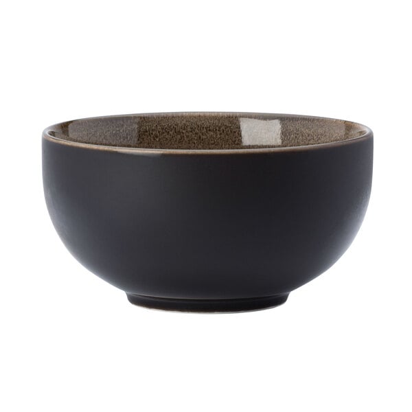 A white porcelain bowl with a brown rim and speckles.