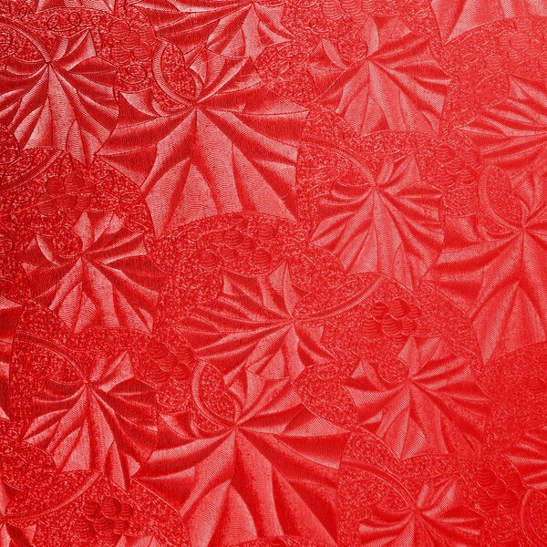 A red surface with a pattern of leaves.