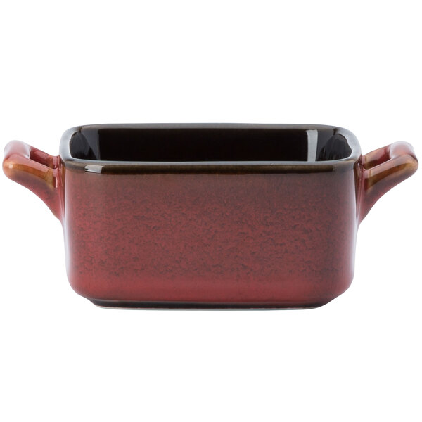 A red square ceramic mini baker with two handles.