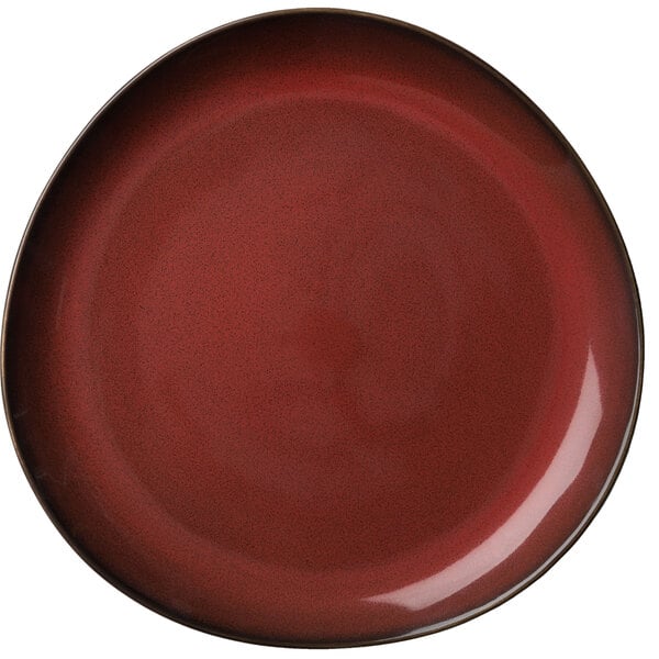 A white porcelain plate with a red center and black rim.