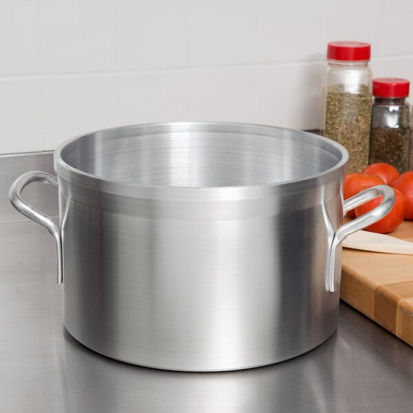 A large silver sauce pot on a stove.