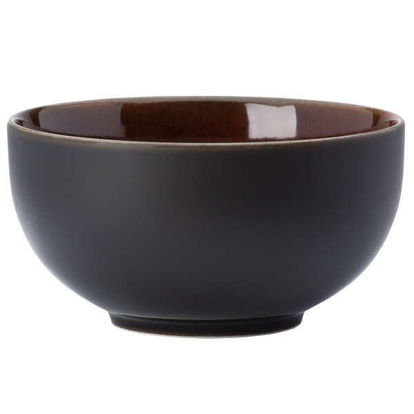 A black bowl with a brown rim.