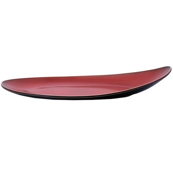 A red porcelain Eclipse plate with a black rim.