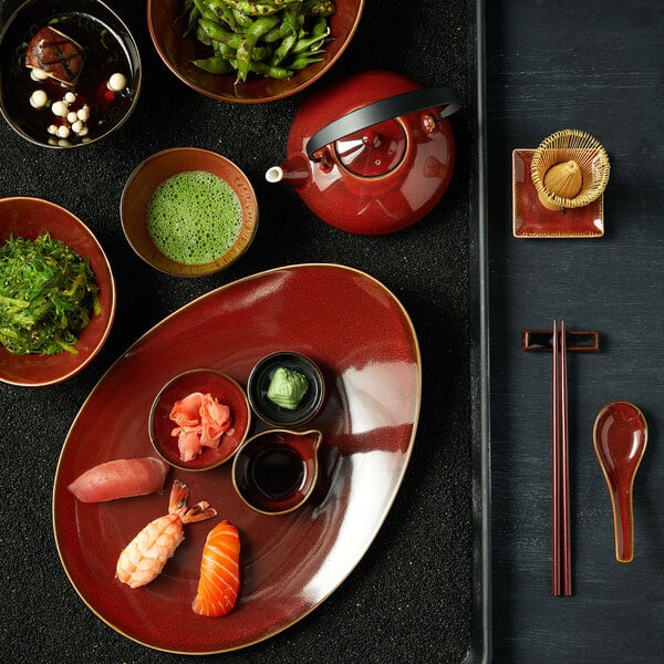 A table set with Oneida Crimson Eclipse porcelain plates filled with various foods.