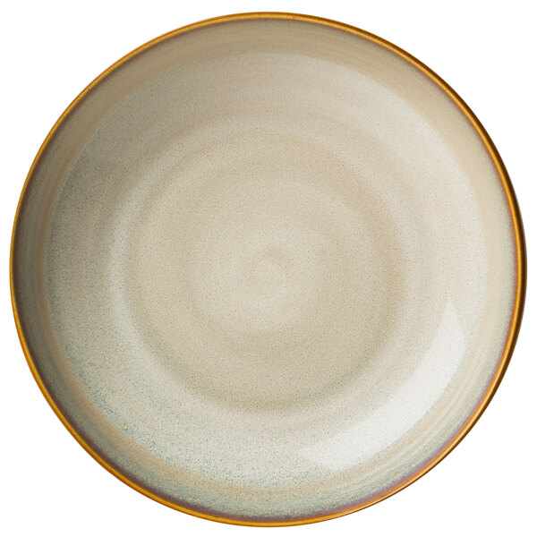 A close-up of a Oneida Rustic Sama porcelain deep coupe plate with a brown rim and white center.