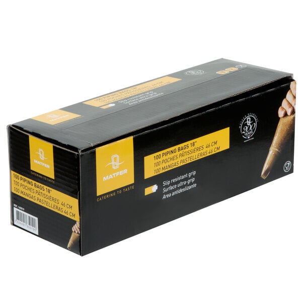 A black box with yellow labels of Matfer Bourgeat Standard Disposable Pastry Bags on a counter.