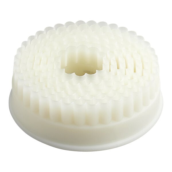 A set of white, round, fluted pastry cutters nested together in a circular arrangement.