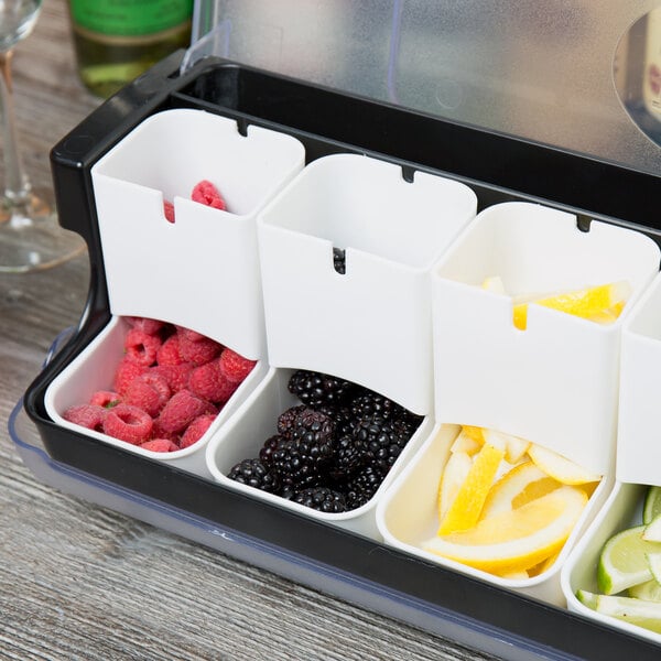 A Tablecraft white container with red food inside sitting on a counter.