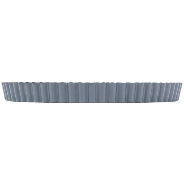 A Matfer Bourgeat fluted non-stick tart pan with a removable bottom on a white background.